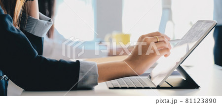 Close up hand of woman hand holding pen stylus writing on digital tablet computer 81123890