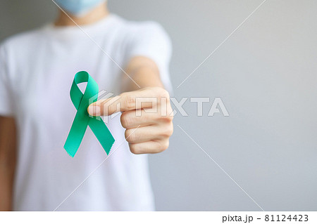 September Ovarian cancer Awareness month, Woman holding teal Ribbon color for supporting people living, and illness. Healthcare and world cancer day concepts September Ovarian cancer Awareness month, Woman holding teal Ribbon color for supporting people living, and illness. Healthcare and world cancer day concepts 81124423