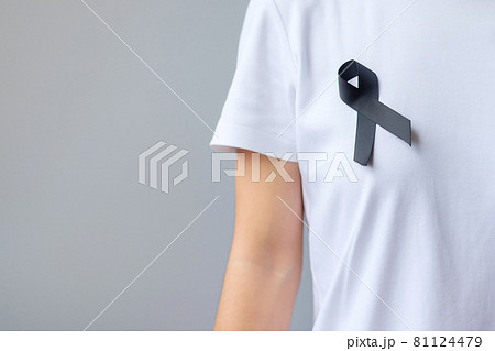 black Ribbon for Melanoma and skin cancer, Vaccine injury awareness month, grief and rest in peace. Healthcare and Racist concept black Ribbon for Melanoma and skin cancer, Vaccine injury awareness month, grief and rest in peace. Healthcare and Racist concept 81124479