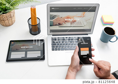 Web designer working with multiple devices 81125648