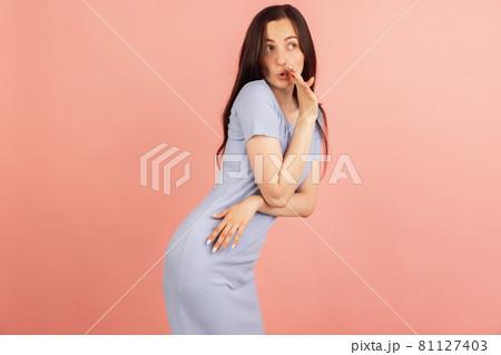 Gossip girl. Portrait of young Caucasian woman posing isolated on pink pastel background. Gossip girl. Portrait of young Caucasian woman posing isolated on pink pastel background. 81127403