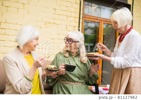 Old friends feeling great while spending time together and drinking tea Old friends feeling great while spending time together and drinking tea 81127962