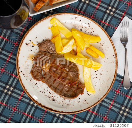 Delicious roasted veal chop served with potato Delicious roasted veal chop served with potato 81129507