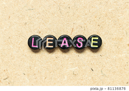 Black color round bead in word lease on wood background Black color round bead in word lease on wood background 81136876