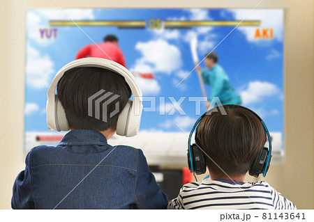 ヘッドセットをつけてテレビゲームを楽しむ男の子の後ろ姿 ヘッドセットをつけてテレビゲームを楽しむ男の子の後ろ姿 81143641