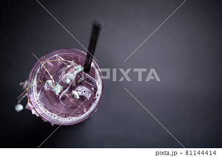 luxury violet fizz cocktail drink with flower decoration on black background luxury violet fizz cocktail drink with flower decoration on black background 81144414