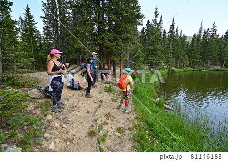 Hikers on shore of Hassell Lake in Arapaho National Forest, Colorado. Hikers on shore of Hassell Lake in Arapaho National Forest, Colorado. 81146183