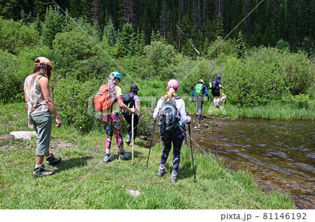 Hikers in shallow water on Hassell Lake Trail in Arapaho Nat'l Forest, Colorado. Hikers in shallow water on Hassell Lake Trail in Arapaho Nat'l Forest, Colorado. 81146192