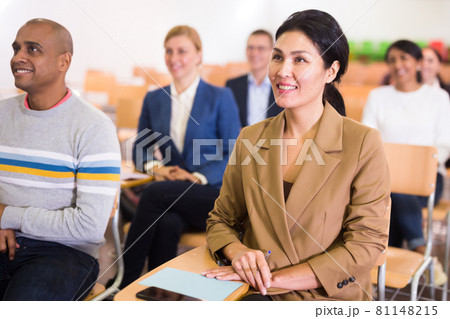 Confident woman listening to lecture at conference Confident woman listening to lecture at conference 81148215