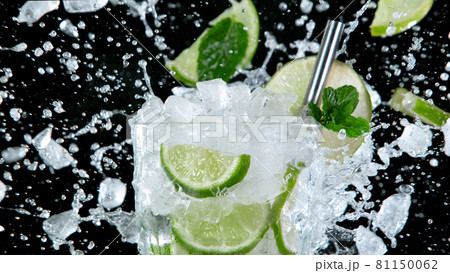 Super Slow Motion of exploding crushed ice towards mojito cocktail. 81150062
