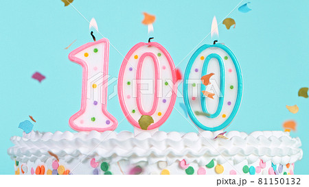 Colorful tasty birthday cake with candles shaped like the number 100. 81150132