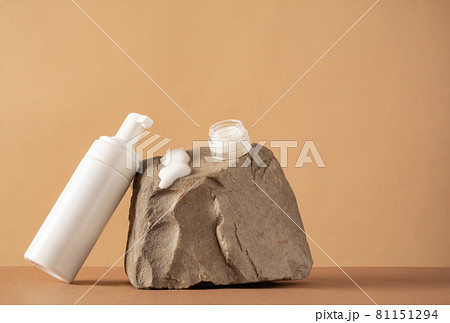 Facial product sample on a stone. A set of cosmetics products with natural materials. Front view, copy space Facial product sample on a stone. A set of cosmetics products with natural materials. Front view, copy space 81151294