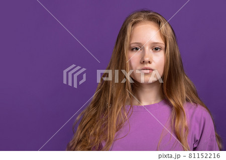 Half-length portrait of young beautiful girl isolated on purple studio background. Concept of human emotions, facial expression, youth, sales, ad. Half-length portrait of young beautiful girl isolated on purple studio background. Concept of human emotions, facial expression, youth, sales, ad. 81152216