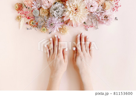 Woman with manicure and flowers Woman with manicure and flowers 81153600