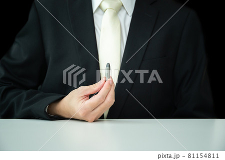 Unrecognizable businessman showing a .38 ammunition. 81154811