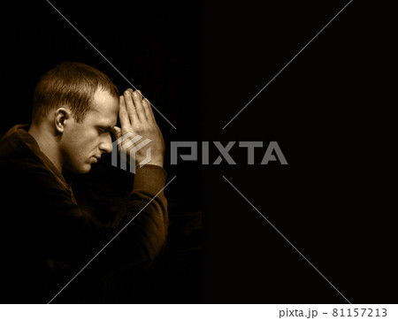Young man praying Young man praying 81157213