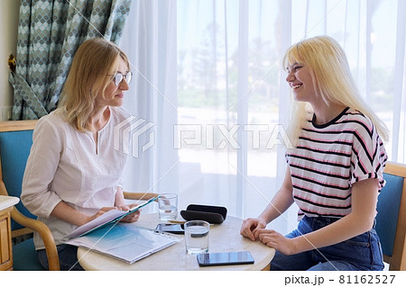 Psychologist consultation, teenage girl at meeting with psychologist in office Psychologist consultation, teenage girl at meeting with psychologist in office 81162527