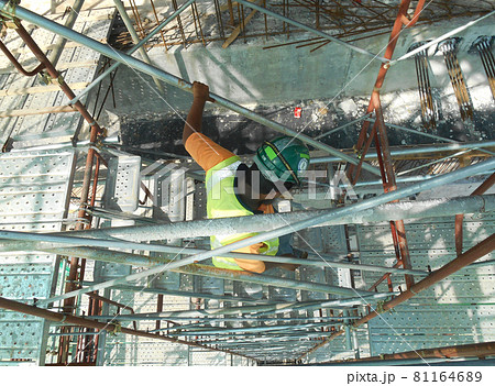 MALACCA, MALAYSIA -SEPTEMBER 23, 2016: Temporary access and staircase supported by reinforced scaffolding at the construction site. Used by construction workers. MALACCA, MALAYSIA -SEPTEMBER 23, 2016: Temporary access and staircase supported by reinforced scaffolding at the construction site. Used by construction workers. 81164689
