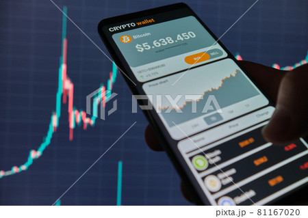 Smartphone with mobile application cryptocurrency wallet. A man analyzes the price chart for bitcoin in a mobile application. The concept of cryptocurrency trading Smartphone with mobile application cryptocurrency wallet. A man analyzes the price chart for bitcoin in a mobile application. The concept of cryptocurrency trading 81167020