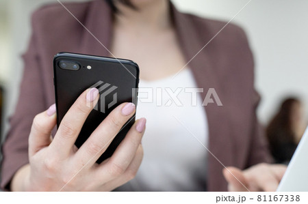 Female office worker typing on the phone, working at home office hand on keyboard Female office worker typing on the phone, working at home office hand on keyboard 81167338