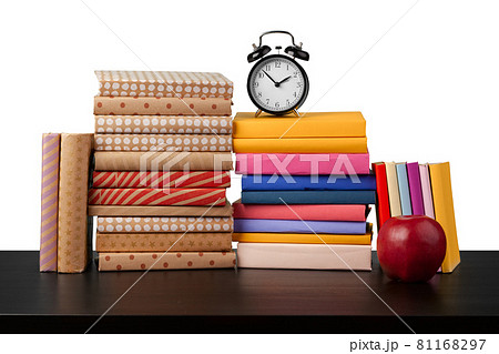 Stack of books and apple on tabletop against white background Stack of books and apple on tabletop against white background 81168297