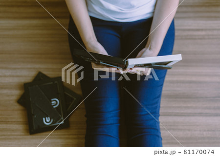 Woman looking photo album at home,Memory time photos,Top view 81170074