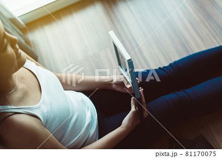 Beautiful happy asian woman looking photo album at home,Memory time photos,Happy and smiling 81170075