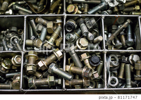 Bolts in an iron box. Screws, tools, nuts, metal. 81171747