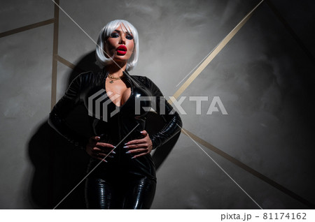 Sexy woman in a blonde wig and latex catsuit. Role-playing games Sexy woman in a blonde wig and latex catsuit. Role-playing games 81174162