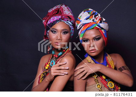 Close Up half body of 20s Asian two Woman with Fashion make up African hill Tribe style 81176431