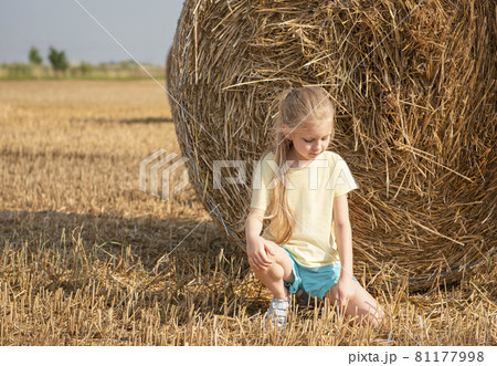 Little girl having fun in a wheat field on a summer day. Little girl having fun in a wheat field on a summer day. 81177998