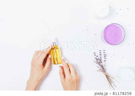 Female hands holding bottle of organic cosmetic oil Female hands holding bottle of organic cosmetic oil 81178256