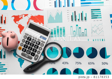 Business graphs paper and calculator on table Business graphs paper and calculator on table 81178353