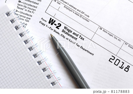 The pen and notebook on the tax form W-2 Wage and Tax Statement. The time to pay taxes The pen and notebook on the tax form W-2 Wage and Tax Statement. The time to pay taxes 81178883