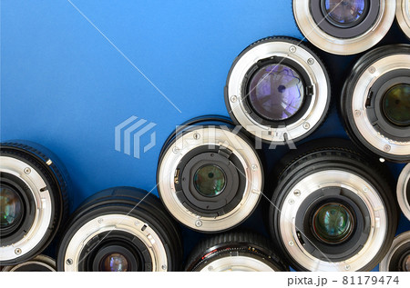 Several photographic lenses lie on a bright blue background. Space for text Several photographic lenses lie on a bright blue background. Space for text 81179474