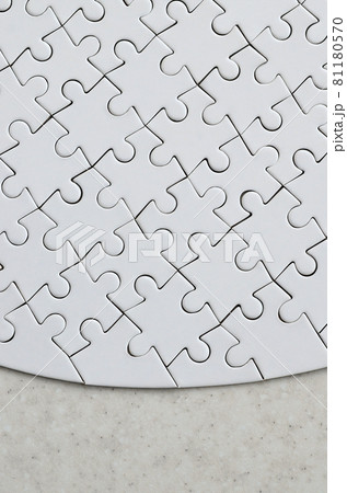 A white jigsaw puzzle in the complete form lies on a treated stone surface. Textured image with copy space A white jigsaw puzzle in the complete form lies on a treated stone surface. Textured image with copy space 81180570