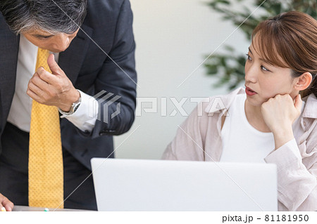 上司からのアドバイスを聞いている若い女性 81181950