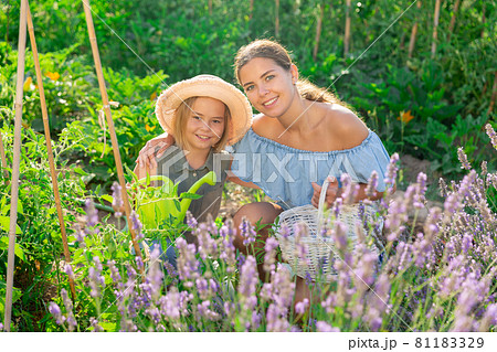 Portrait of mom with little daughter on farm field Portrait of mom with little daughter on farm field 81183329