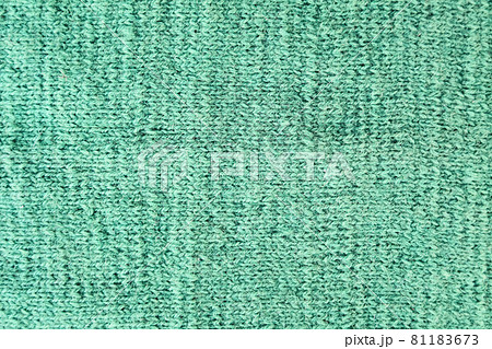 Natural woolen fabric fragment. Knitted texture closeup. Warm yarn background. Natural woolen fabric fragment. Knitted texture closeup. Warm yarn background. 81183673