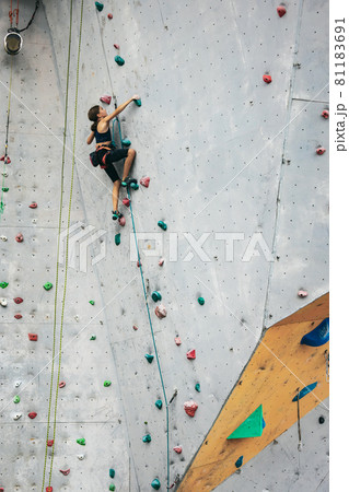 One cute teen girl with climbing equipment practicing on rock wall outdoors. Little hiker. Active lifestyle concept 81183691