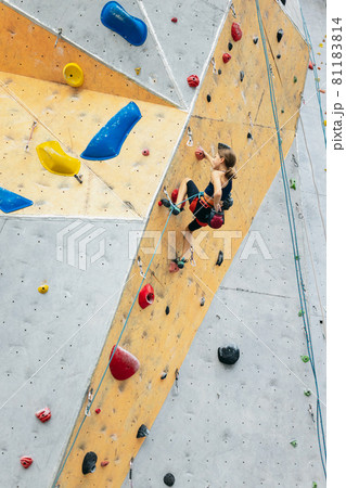 One cute teen girl practicing on the rock wall in climbing center. Concept of sportive lifestyle, activity, happy childhood 81183814