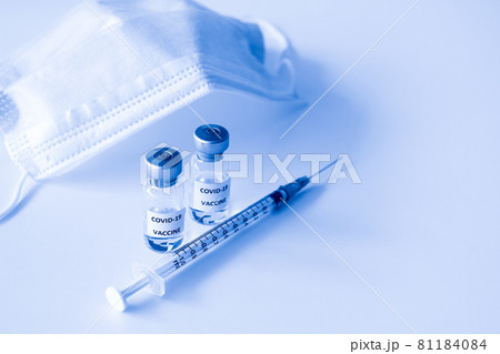 Covid-19 Prevention concept : vial of Covid-19 vaccine, 1 ml plastic syringe with needle and mask Covid-19 Prevention concept : vial of Covid-19 vaccine, 1 ml plastic syringe with needle and mask 81184084