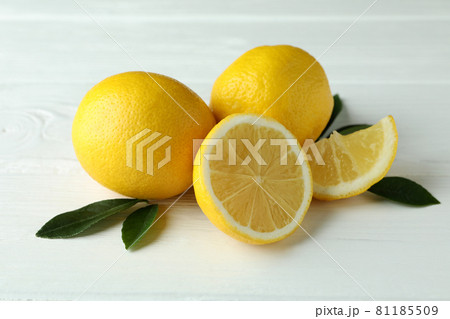 Ripe lemons on white wooden background, close up 81185509