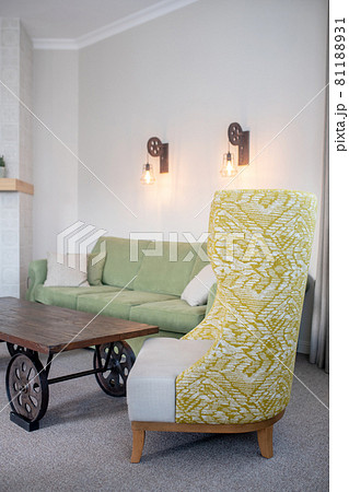High back upholstered armchair in living room High back upholstered armchair in living room 81188931