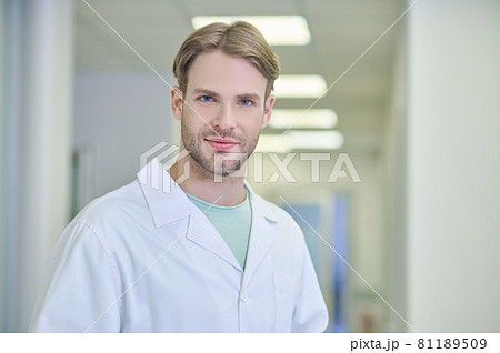Tranquil attractive doctor posing for the camera in the workplace Tranquil attractive doctor posing for the camera in the workplace 81189509