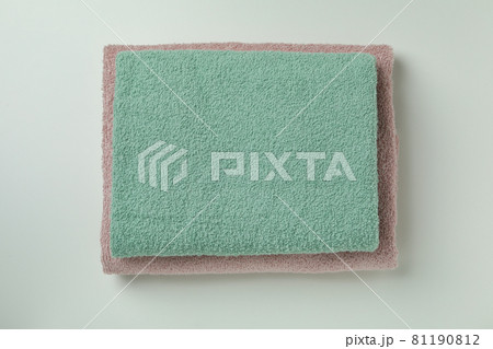 Clean folded towels on light gray background, top view Clean folded towels on light gray background, top view 81190812