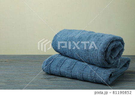 Clean folded towels on gray wooden table, space for text Clean folded towels on gray wooden table, space for text 81190852