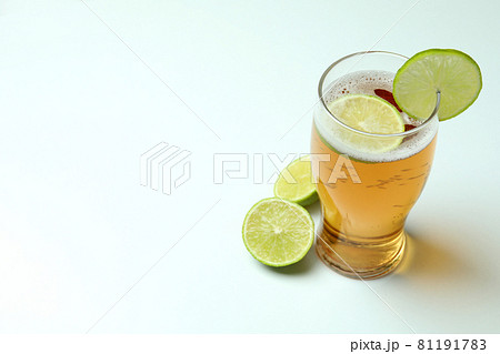 Glass of beer with lime on white background 81191783