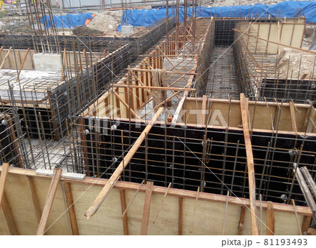 PERAK, MALAYSIA -JUNE 30, 2016: Construction workers fabricating timber form work mostly using timber and plywood at the construction site. PERAK, MALAYSIA -JUNE 30, 2016: Construction workers fabricating timber form work mostly using timber and plywood at the construction site. 81193493