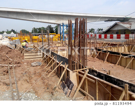 PERAK, MALAYSIA -JUNE 30, 2016: Construction workers fabricating timber form work mostly using timber and plywood at the construction site. PERAK, MALAYSIA -JUNE 30, 2016: Construction workers fabricating timber form work mostly using timber and plywood at the construction site. 81193494